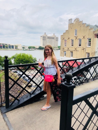 Jayda walking across bridge overlooking River Street Savannah Historic District